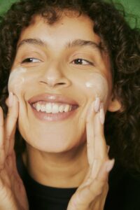 woman rubbing moisturizer onto face
